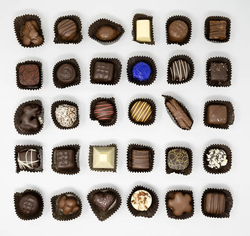 An assortment of filled chocolates laid out in rows