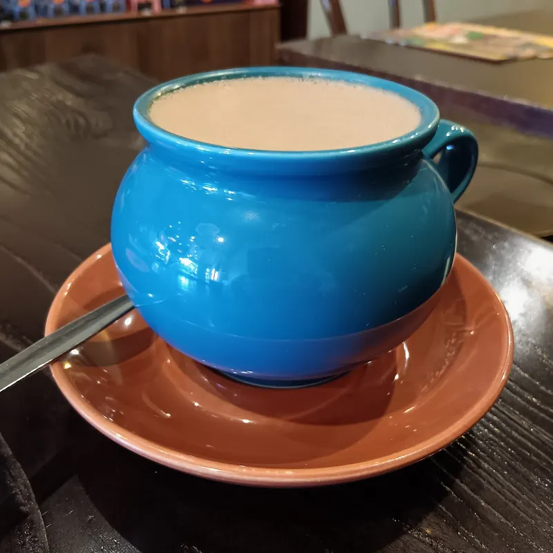 A thick dark hot chocolate in a blue mug