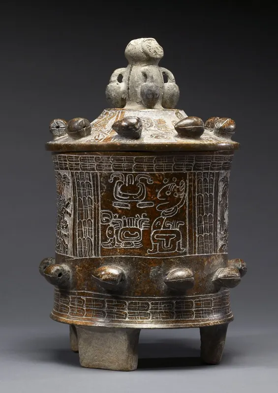 A carved Maya lidded vessel of the kind used for serving cacao