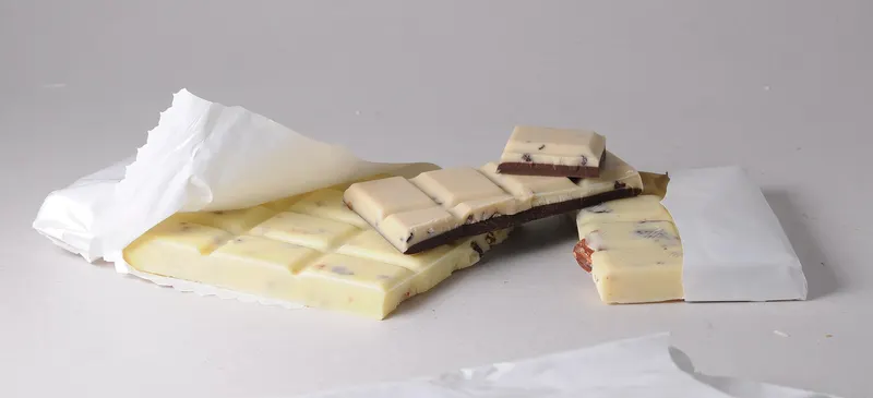 A bar of white chocolate broken into squares